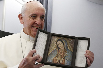 Pope holds image of Our Lady of Guadalupe after receiving gift from journalist aboard papal flight to Brazil